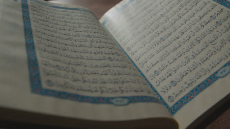 Handheld-Shot-of-the-Quran-Religious-Text-Pages